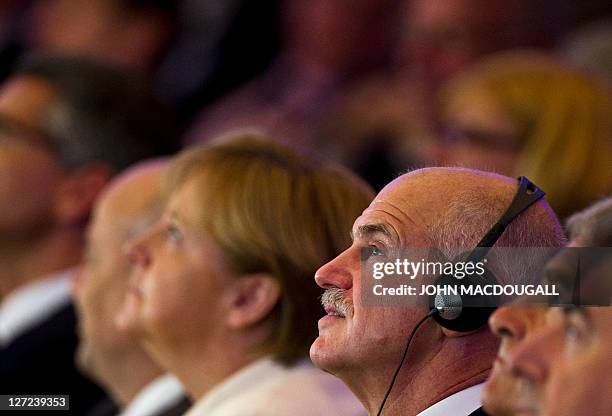 Greek Prime Minister George Papandreou and German Chancellor Angela Merkel follow a meeting of the Federation of German Industry in Berlin on...