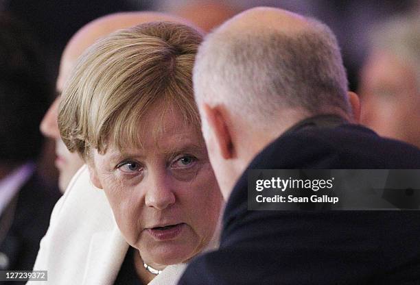 German Chancellor Angela Merkel speaks with Greek Prime Minister George Papandreou at a convention of the Federation of German Industry , where...