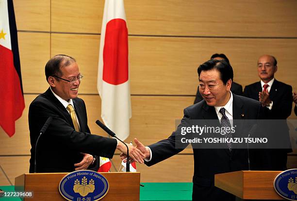 Visiting Philippine President Benigno Aquino shakes hands with Japanese Prime Minister Yoshihiko Noda after they delivered their joint statement...