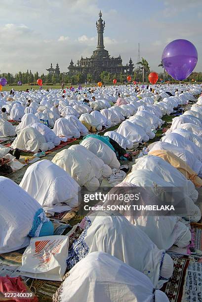 Indonesian Muslims take part in a special morning prayer near Bajrah Sandhi Hindu's temple in Denpasar on Bali island on October 1, 2008. Muslims...