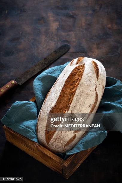 wholegrain rye bread loaf in wooden box tray over dark wood - cereal boxes stock pictures, royalty-free photos & images