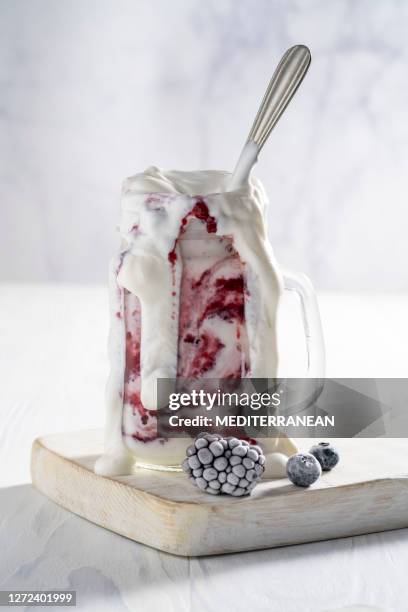raspberries yogurt smoothie overflow with frozen berries - overflowing stock pictures, royalty-free photos & images