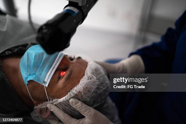 patient on an eye surgery - cataract eye stock pictures, royalty-free photos & images