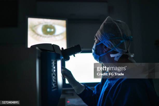 doctor doing an exam or surgery, looking at images in monitor - surgery stock pictures, royalty-free photos & images