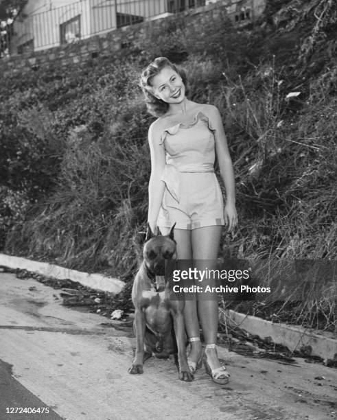 American actress, singer, and dancer Mitzi Gaynor with dog Ruff-Tuff, US, circa 1950.