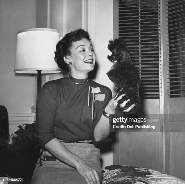 American actress, singer, dancer, and philanthropist Jane Wyman holding a Miniature Poodle Dog in her hand, US, 17th January 1955.