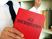 A lawyer shows an Age discrimination law book.