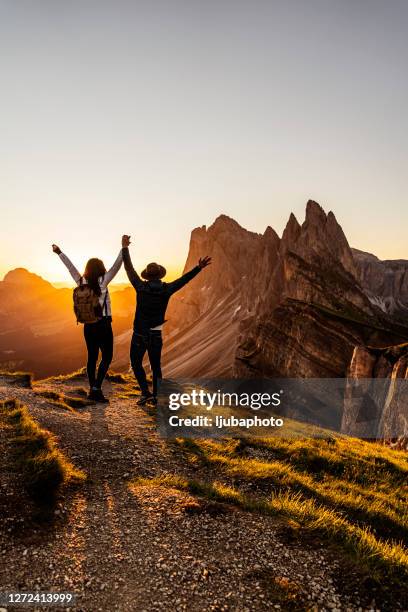 two happy tourists greetings sunrise in mountains - mountain peak sunrise stock pictures, royalty-free photos & images