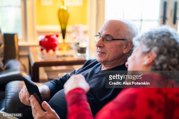 saving guarantee the worry-less retirement. senior couple shopping online using tablet. - christmas savings stock pictures, royalty-free photos & images