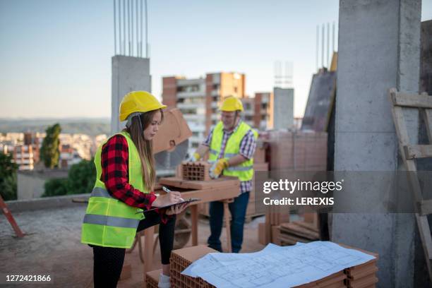 a young student keeps notes on a construction site - person in suit construction stock pictures, royalty-free photos & images