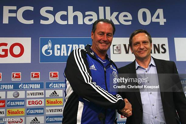 Head coach Huub Stevens and Horst Heldt shake hands during the FC Schalke press conference at the Veltins Arena on September 27, 2011 in...