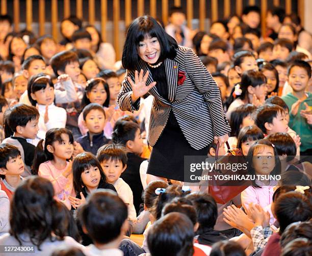 Japan's first lady Miyuki Hatoyama is greeted by some 600 children from Beijing's Japanese school during a visit in Beijing on October 10, 2009....