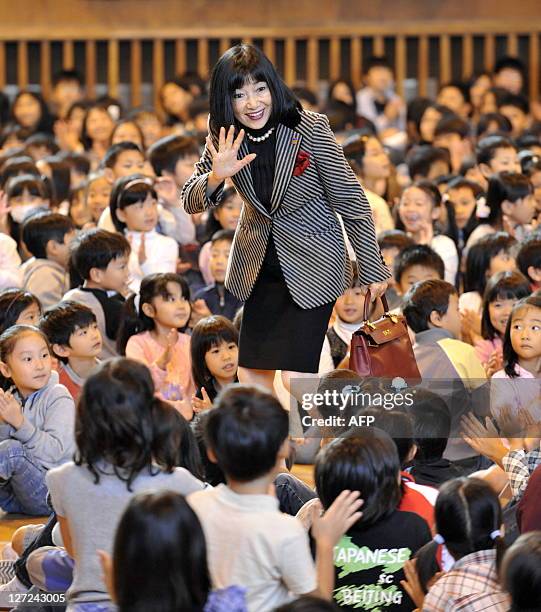 Japan's first lady Miyuki Hatoyama is greeted by some 600 children from Beijing's Japanese school during a visit in Beijing on October 10, 2009....