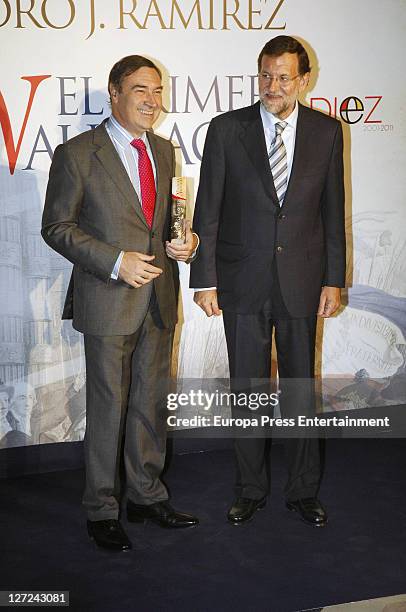 Spanish newspaper El Mundo Pedro J. Ramirez and leader of the Spanish opposition Party Mariano Rajoy pose during the presentation of the book 'El...