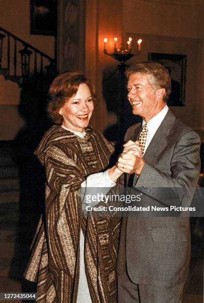 First Lady Rosalynn Carter and President Jimmy Carter smile as they dance together in the Grand foyer of the White House, Washington DC, January 31,...