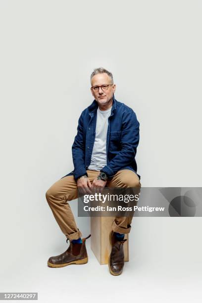 middle-aged hipster man wearing blue jacket - cuarentena fotografías e imágenes de stock