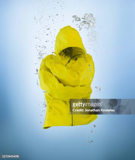 yellow jacket underwater - gabardina ropa impermeable fotografías e imágenes de stock