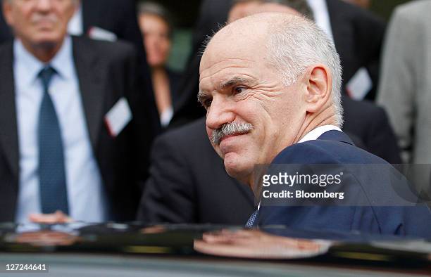 George Papandreou, Greece's prime minister, leaves after speaking at the BDI federation of German industries conference in Berlin, Germany, on...
