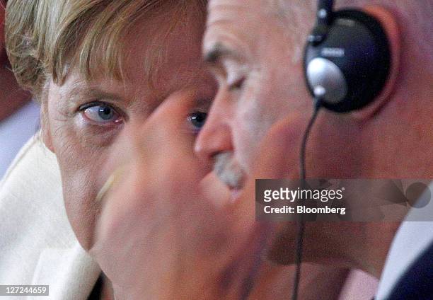 Angela Merkel, Germany's chancellor, left, speaks with George Papandreou, Greece's prime minister, during the BDI federation of German industries...