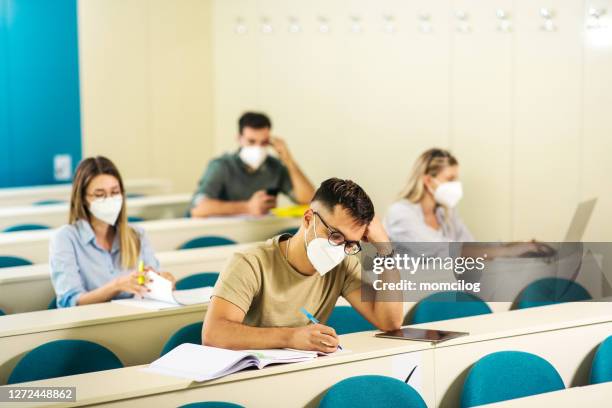 college students in classroom during covid-19 - secondary school covid stock pictures, royalty-free photos & images