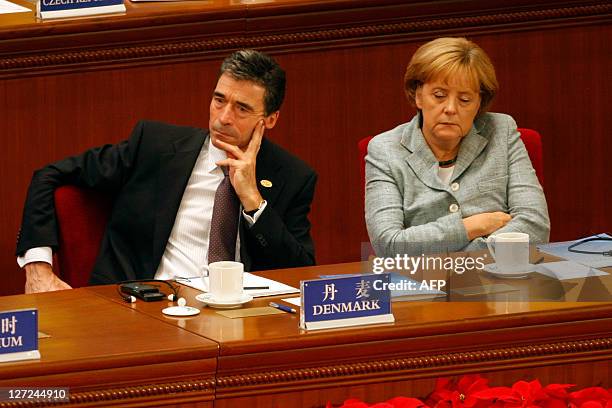 Anders Fogh Rasmussen , Prime Minister of Denmark and Angela Merkel , Chancellor of Germany attend the opening ceremony of the 7th Asia-Europe...