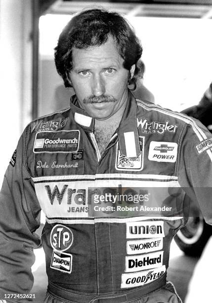 Driver Dale Earnhardt Sr. Stands in the speedway garage prior to the start of the 1983 Daytona 500 stock car race at Daytona International Speedway...