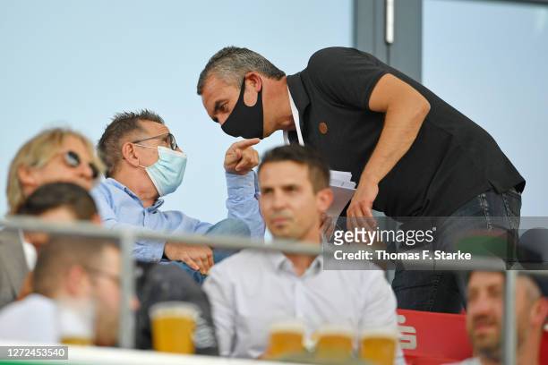 Former Bielefeld head coach Norbert Meier chats with manager Marcus Uhlig of Essen during the DFB Cup first round match between Rot-Weiss Essen and...