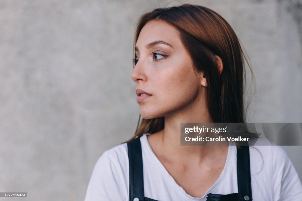 Close up portrait of young hispanic woman aged 20-24 years with a serious emotion