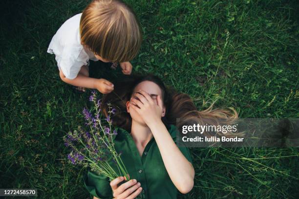 mother and her child enjoy the early spring - family moments stock-fotos und bilder