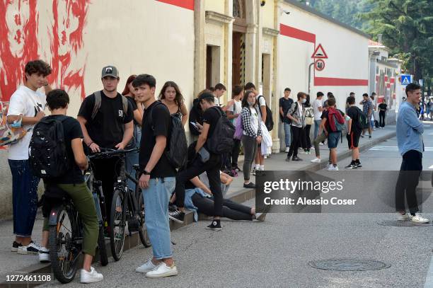 General view of young people with some wearing protective masks others without masks outside a school when leaving a school after the first day of...