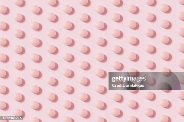 circle shaped pills on pink background - pill background stock pictures, royalty-free photos & images