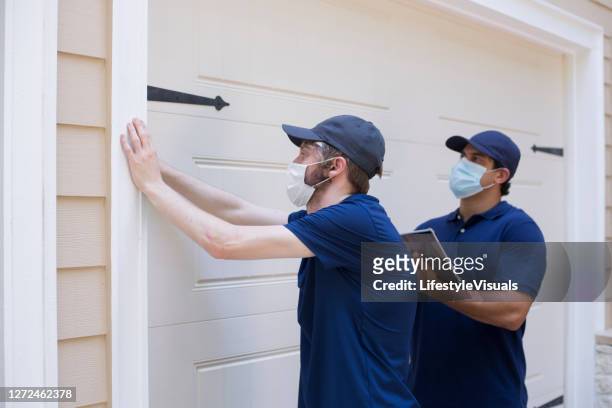 inspector or blue collar workers examine building walls.  outdoors. - pests stock pictures, royalty-free photos & images