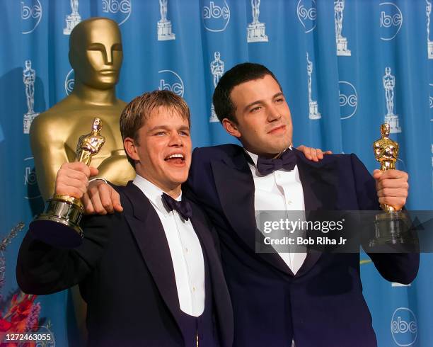 Winners Ben Affleck and Matt Damon hold their Oscar Awards backstage at Academy Awards Show, March 23, 1998 in Los Angeles, California