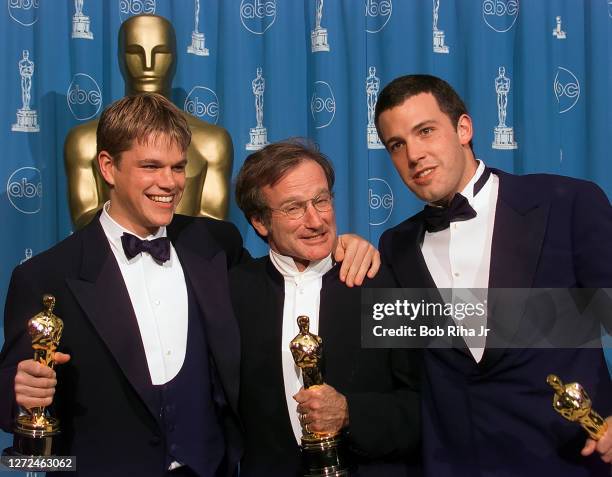 Robin Williams joins winners Ben Affleck and Matt Damon hold their Oscar Awards backstage at Academy Awards Show, March 23, 1998 in Los Angeles,...