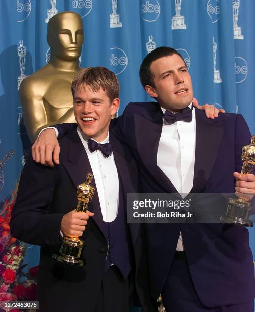 Winners Ben Affleck and Matt Damon hold their Oscar Awards backstage at Academy Awards Show, March 23, 1998 in Los Angeles, California