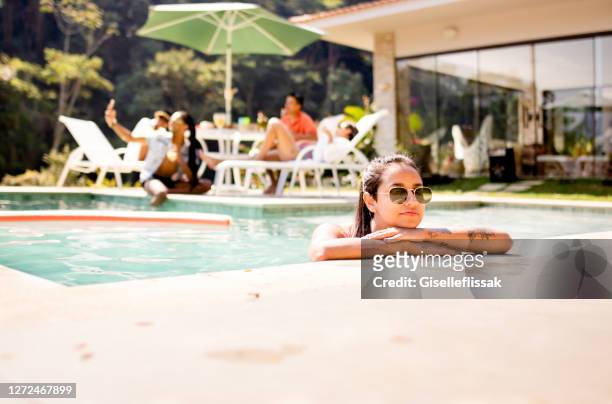 friends hanging out in the pool in the backyard - pool party stock pictures, royalty-free photos & images