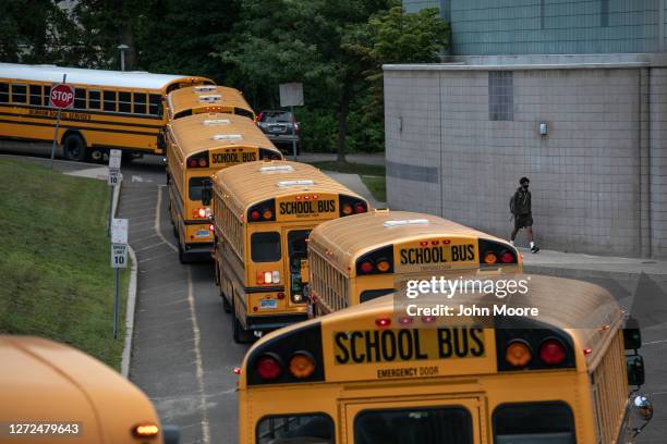 Busses depart after dropping off students at Rippowam Middle School on September 14, 2020 in Stamford, Connecticut. Most students there are taking...