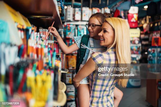 mother and daughter in a bookstore - school supplies stock pictures, royalty-free photos & images