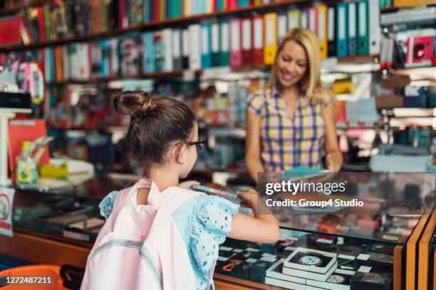 mother and daughter in a bookstore - book shop stock pictures, royalty-free photos & images