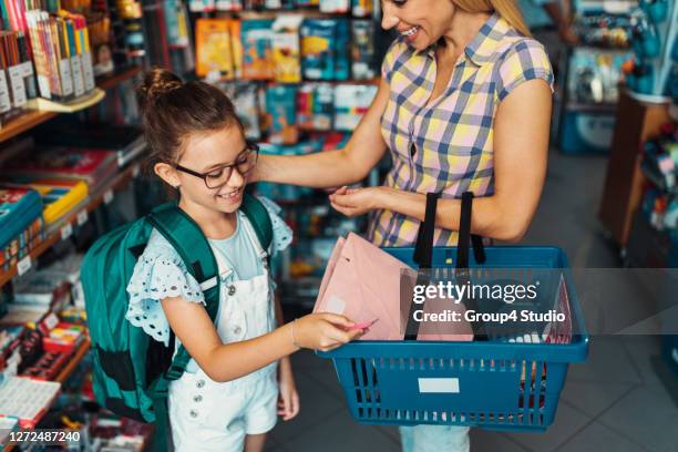 mother and daughter in a bookstore - school supplies stock pictures, royalty-free photos & images