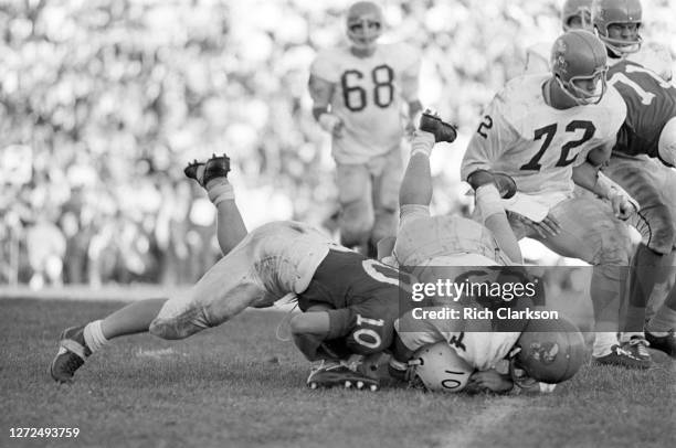 An unknown Kansas Jayhawks player tackles Fred Duda of the Nebraska Cornhuskers on November 9, 1963 in Lincoln, NE.