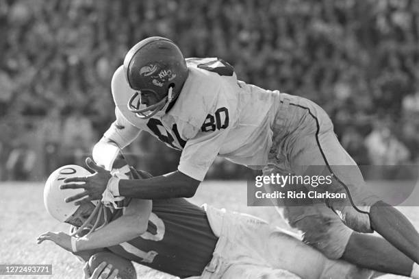 An unknown Kansas Jayhawks player tackles Fred Duda of the Nebraska Cornhuskers on November 9, 1963 in Lincoln, NE.