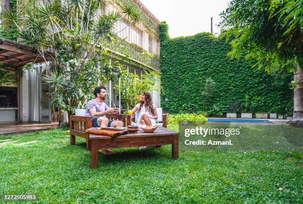 weekend breakfast and conversation in backyard - sunny backyard stock pictures, royalty-free photos & images