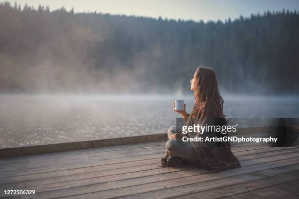 woman relaxing in nature. - lake stock pictures, royalty-free photos & images