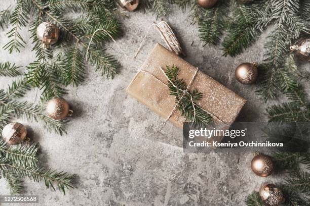 christmas and zero waste, eco friendly packaging. woman is wrapping gifts in craft paper on a wooden table, ecological christmas holiday concept, eco decor - hessian stock pictures, royalty-free photos & images