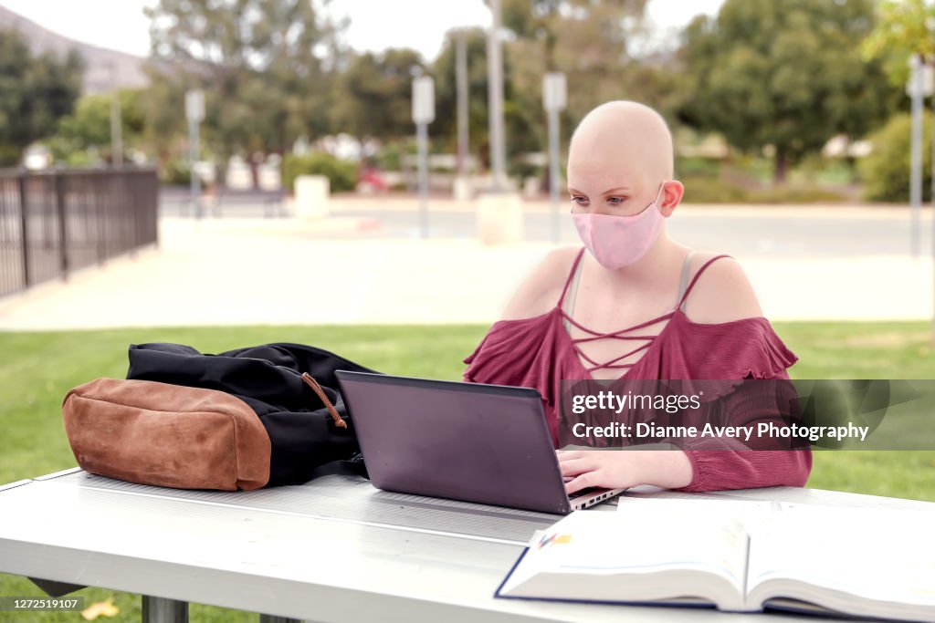 Bald female college student with cancer