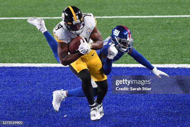 JuJu Smith-Schuster of the Pittsburgh Steelers scores a touchdown as James Bradberry of the New York Giants defends during the second half at MetLife...
