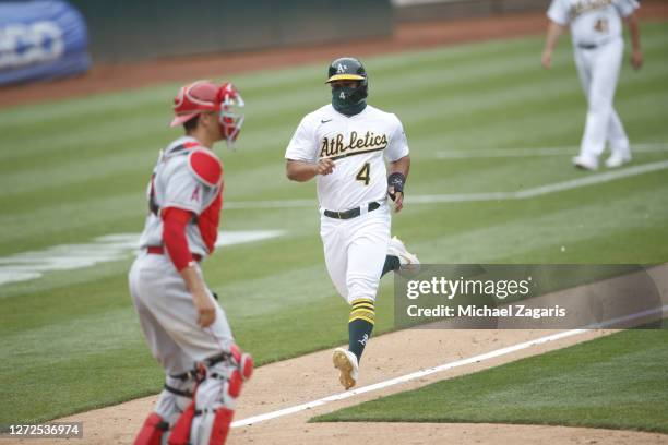 Franklin Barreto of the Oakland Athletics scores the winning run during the game against the Los Angeles Angels at RingCentral Coliseum on August 23,...