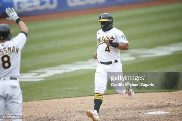 Franklin Barreto of the Oakland Athletics scores the winning run during the game against the Los Angeles Angels at RingCentral Coliseum on August 23,...