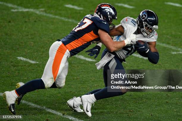 Josey Jewell of the Denver Broncos tackles Khari Blasingame of the Tennessee Titans during the second half of Tennessee's 16-14 win on Monday,...